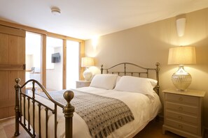 Cozy retreat with a large bed, bedside tables, and a wardrobe.