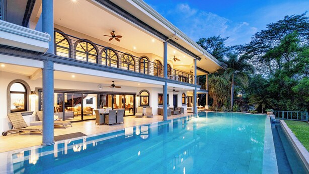 A large, modern house with a swimming pool, multiple levels, and outdoor seating areas. - Playa Hermosa Luxe Villa • 4BR • 5BA • Infinity Pool & Ocean Views (Playa Hermosa)
