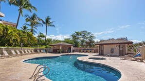 A swimming pool with a curved design, surrounded by lounge chairs and palm trees. - ON SALE! Cozy Maui Studio With Beach + Pool (Kihei)