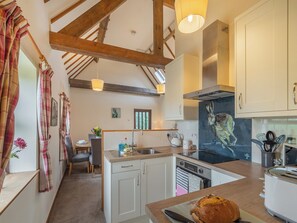 A kitchen with wooden beams, a central island, a stove, and a toaster. - The Granary - UK44490 (Sedgefield)