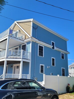 A two-story house with a balcony and a garage. - Great home minutes from beautiful Moody Beach, for the perfect beach vacation! (Wells)