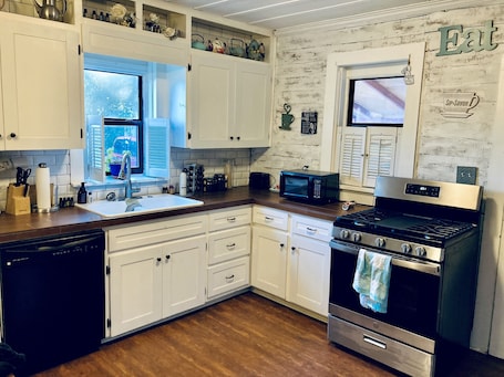 Fridge, microwave, oven, stovetop. The Charming House