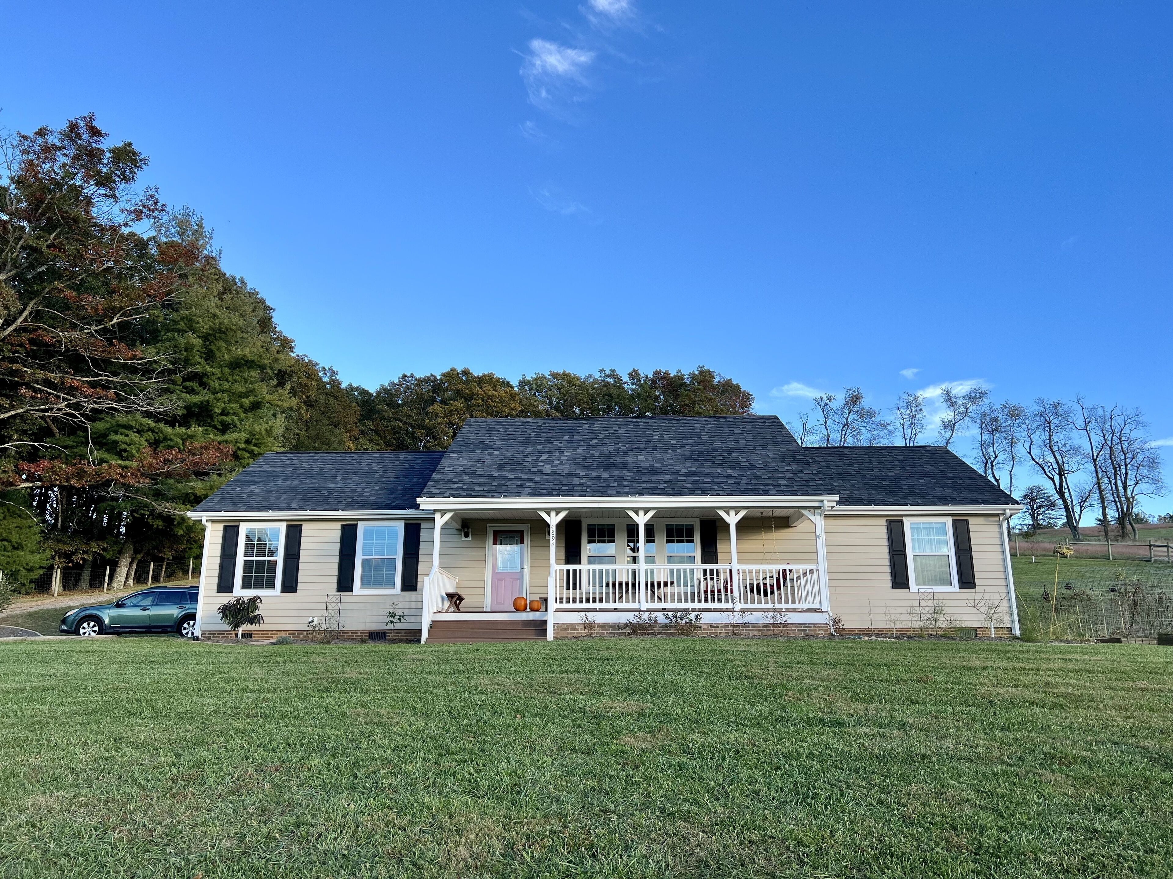 A single-story house with a front porch, a garage, and a well-maintained lawn.