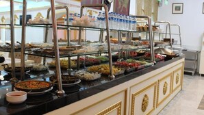 A buffet setup with various food items and beverages. - Hotel Genatsvale Batumi (Batumi)