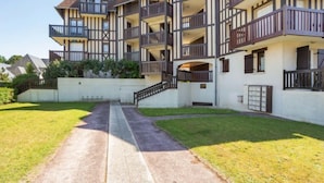 A multi-story building with a traditional architectural style, featuring balconies and a central staircase. - Le Clos Mathilde by Interhome (Cabourg)