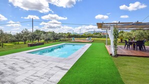 A swimming pool with a surrounding patio area, a pergola with a table and chairs, and a view of the mountains in the background. - Gorgeous home in Santa Maria a Monte (Santa Maria a Monte)