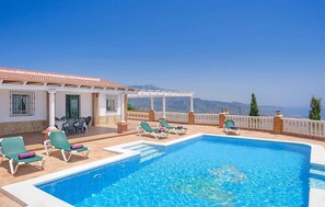 A pool area with lounge chairs and a pergola overlooking a mountainous landscape. - Awesome home in Frigiliana/Torrox (Frigiliana/Torrox)