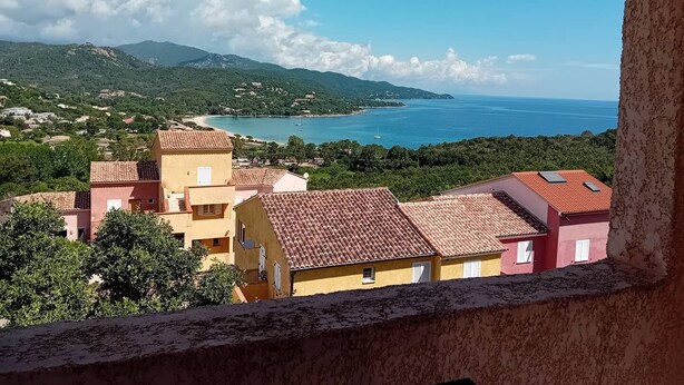 A coastal view with buildings and a clear sky.