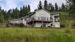 A two-story house with a balcony, surrounded by tall trees and a grassy field. - Hawk's Nest
Entire 1650 Sqft lower level.  (Moscow)