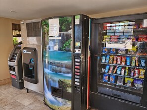 A vending machine with snacks and a water dispenser. - Executive Inn Oklahoma City NorthWest (Oklahoma City)