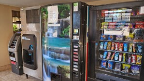 A vending machine with snacks and a water dispenser. - Executive Inn (Oklahoma City)