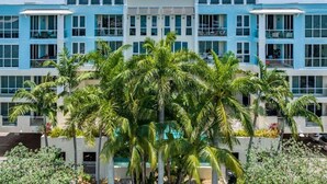 A multi-story hotel with a modern design, featuring balconies and large windows. - Coastal Condo Retreat: 3BR 2.5BA w/ Heated Infinity Pool (Deerfield Beach)
