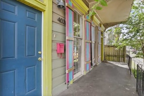 A building with a blue door, a number '403' on the wall, and colorful shutters.