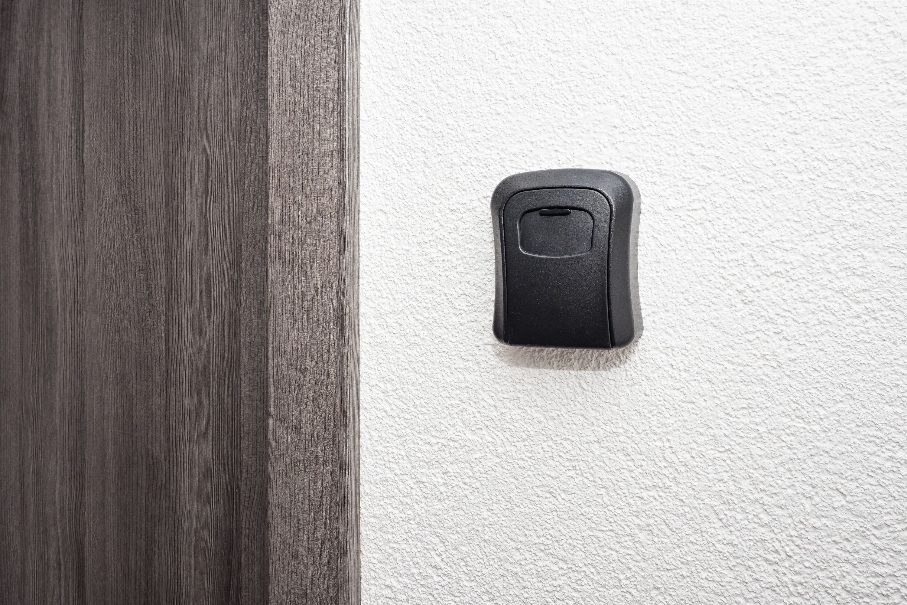 A door with a textured white wall beside it.