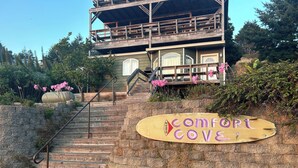 A wooden staircase leading to a building with a sign reading "Comfort Cove."