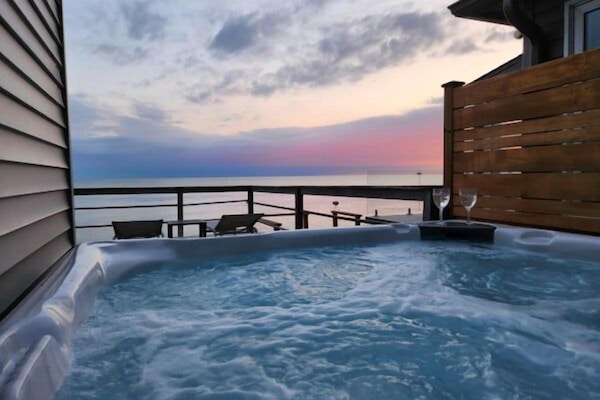 Unwind in the hot tub with unforgettable evening views.