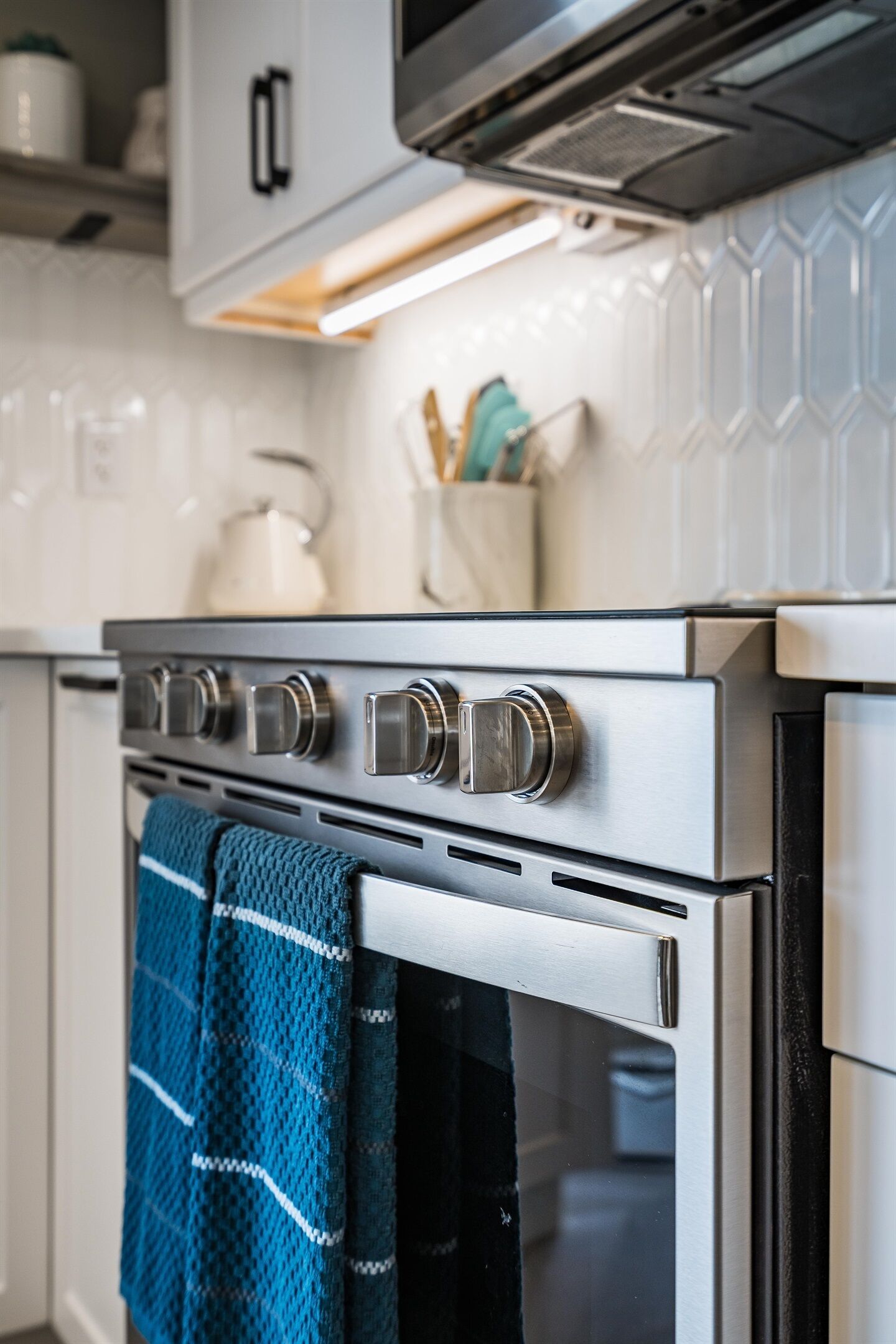 A kitchen with stainless steel appliances, including an oven and a microwave.