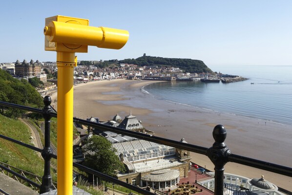 Stroll along the well-maintained promenade, taking in the views of the historic town and the calm sea.