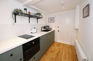 Enjoy cooking and dining in this well-equipped kitchen with a dishwasher, kettle, and ample countertop space.