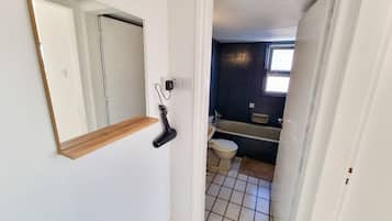 Separate bathtub and shower, towels