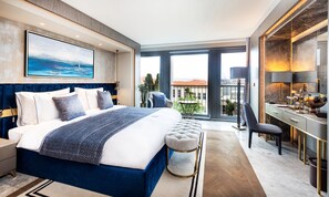 A modern hotel room with a large bed, a desk, and a view of the city. - The Maestro Hotel (Istanbul)