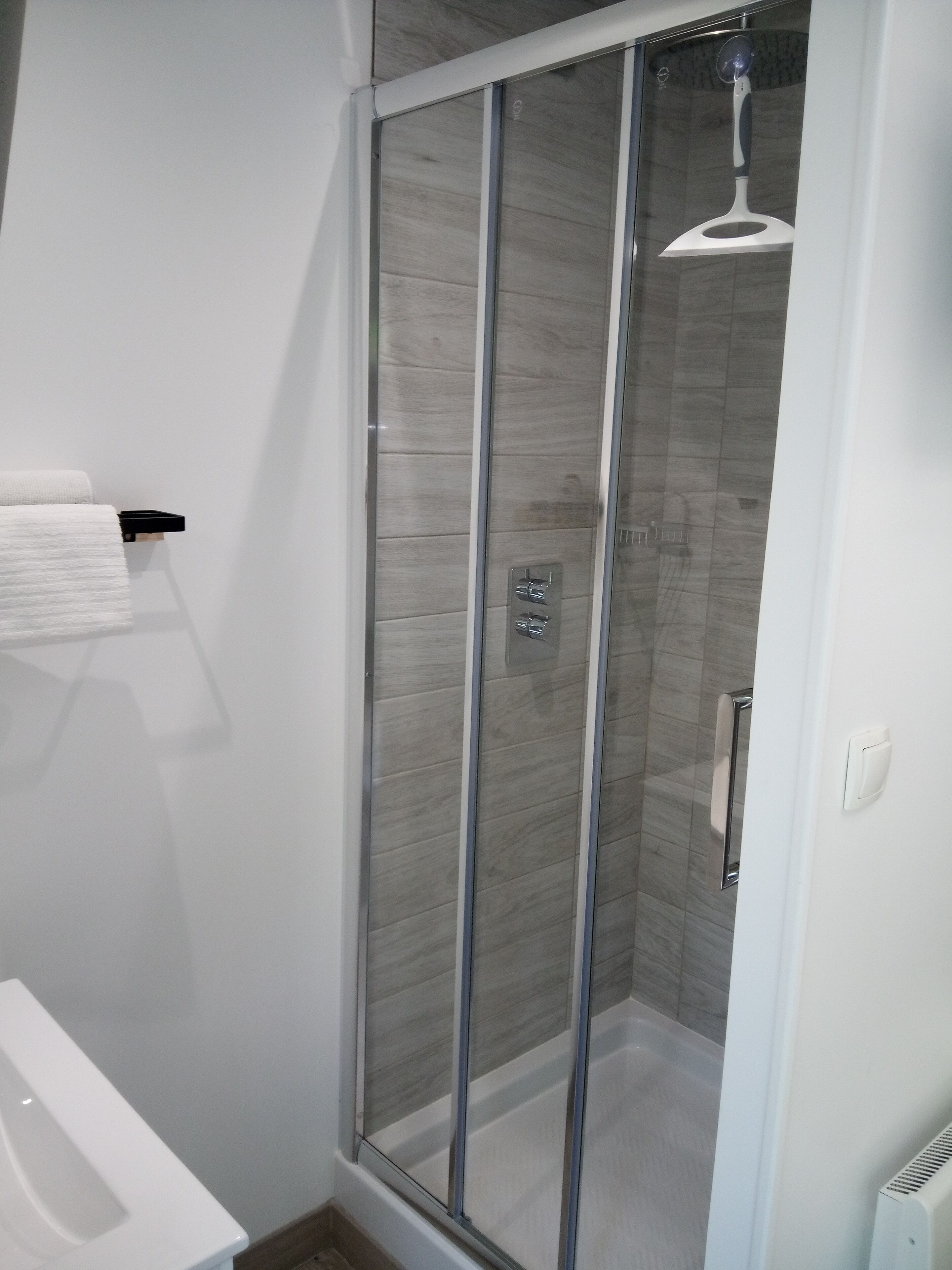 Shower, rainfall showerhead, hair dryer, towels