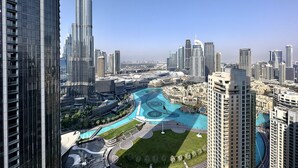 A high-rise building with a view of a cityscape, including a river and surrounding buildings. - Lux BnB Opera Grand Burj Khalifa & Fountain View (Dubai)