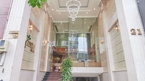 The entrance of a hotel with a grand staircase, a reception desk, and a sign reading "Osia Hotel". - Bin Bin 10 - Mimosa Hotel near Tan Son Nhat Airport (Ho Chi Minh City)