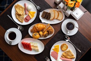 A breakfast spread with various dishes and drinks on a table. - Ayva Hotel (Tashkent)