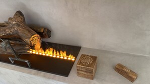 A fireplace with logs and a modern design.
