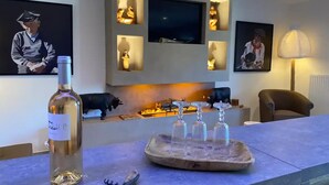A modern living room with a fireplace, a TV mounted on the wall, and various decorative items.