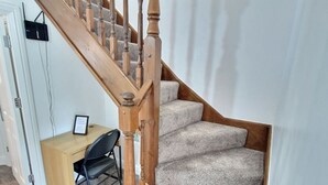 A wooden staircase with carpeted steps leading to a landing. - NightRest Homes 6 Bedroom Short & Long Term Smart Tv in each Room, Free Parking  (Oxley Park)