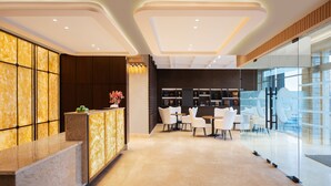 A modern hotel lobby with a reception desk, seating area, and glass walls. - Fortune Ranjit Vihar, Amritsar - Member ITC Hotels' Group (Amritsar)