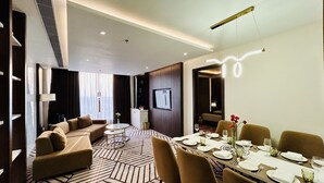 A modern hotel room with a dining area, a sofa, and a TV. - Fortune Ranjit Vihar, Amritsar - Member ITC Hotels' Group (Amritsar)