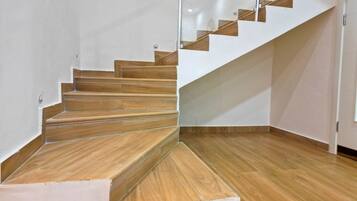 A staircase with wooden steps and a glass railing.