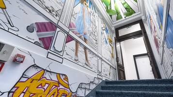 Una escalera con grafitis y una puerta que da a otra habitación.