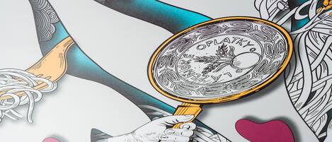 A hand holding a magnifying glass over a detailed illustration.