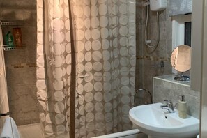 Separate bathtub and shower, deep-soaking bathtub, towels