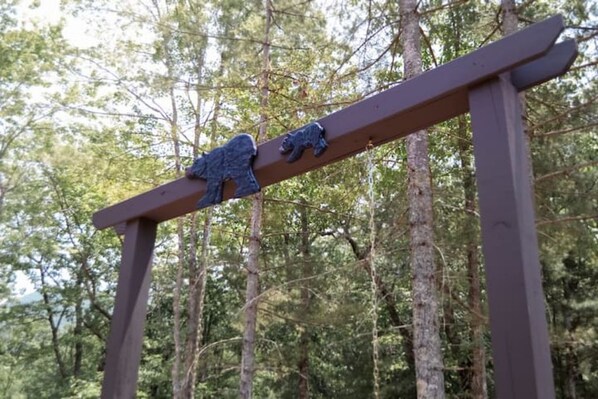 A wooden signpost with bear sculptures in a forest setting. - Cozy Mountain retreat on Wears Valley, Modern Rustic Cabin! (Townsend)