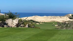 Campo de golf con vista despejada al océano.