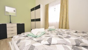 A bedroom with a bed, a dresser, a mirror, and a window with curtains. - Zalazak Sunca by Interhome (Novigrad (Zadar))