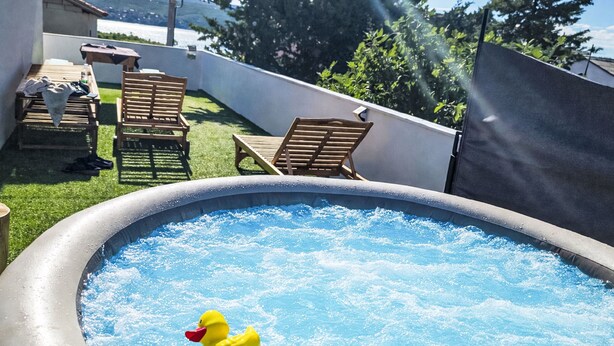 An outdoor swimming pool with inflatable toys, surrounded by a patio area with chairs and a table. - Zalazak Sunca by Interhome (Novigrad (Zadar))
