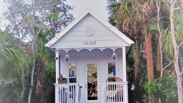 A small, single-story building with a white exterior, a balcony, and a number sign indicating it is property No. 245. - Delightful Cottage in Historic Downtown St. Augustine Florida (St. Augustine)