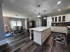 Enjoy meals in the kitchen with a central island, oven, and dining area.