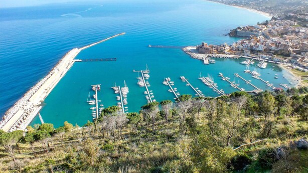 A coastal town with a marina filled with boats, a beach, and a hilly landscape. - Nice home in Terrasini (Terrasini)