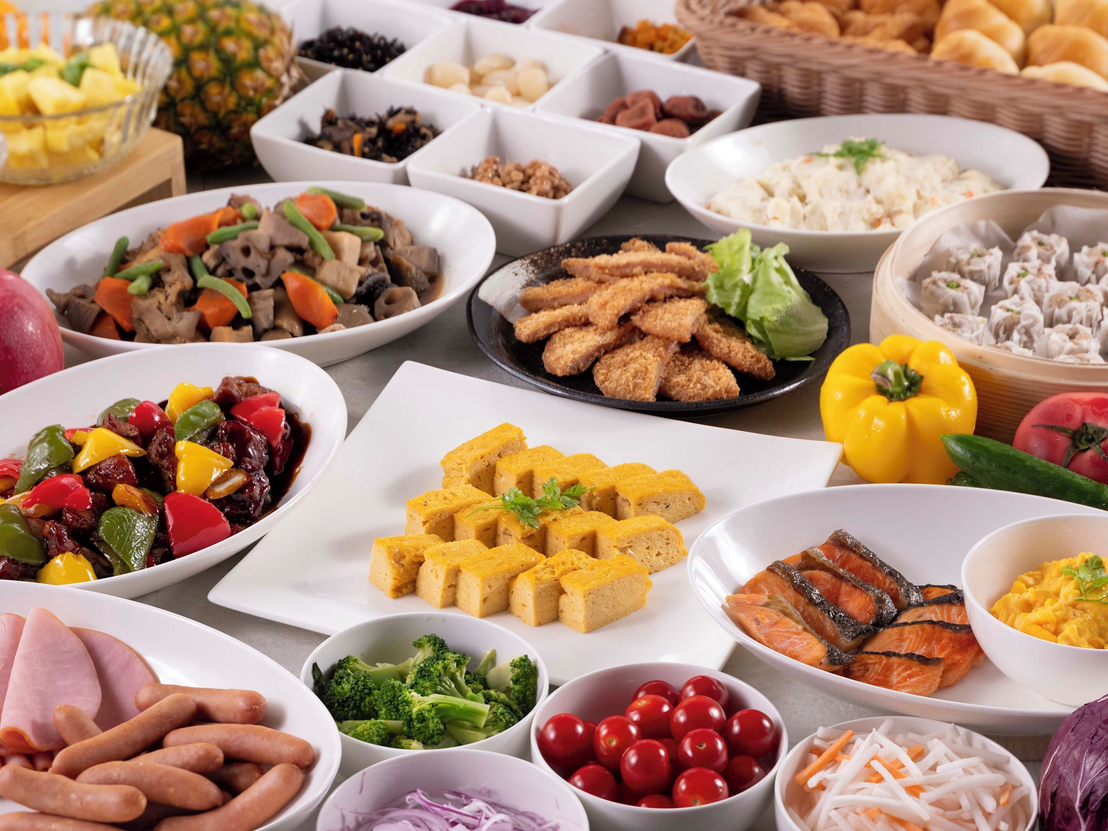 A variety of dishes including sushi, vegetables, and seafood.