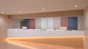 A reception desk with a modern design, featuring a white countertop, a built-in computer, and a flat-screen TV. - HOTEL MYSTAYS Atsugi (Atsugi)