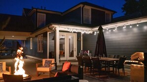 An outdoor patio with a fire feature, seating, and a grill. - Luxury Design, Prime Location 2 Minutes from Midtown, Family Fun! (Memphis)