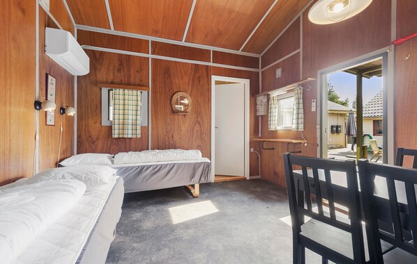 A bedroom with a bed, a chair, a window, and a door. - 4 bedroom beautiful home in Oksbøl (Oksbøl)
