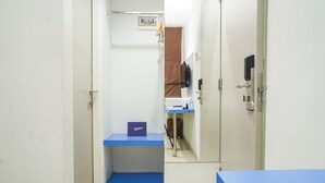 A narrow hallway with a blue counter and a sign that reads "sangagoh". - Singgahsini Rock Gubeng (Surabaya)